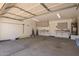 Spacious garage with ample storage cabinets and shelving at 3441 E Melody Dr, Phoenix, AZ 85042
