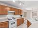 Kitchen with white appliances, overhead lighting and sliding glass door to back yard at 3441 E Melody Dr, Phoenix, AZ 85042