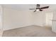 Bright living room features neutral carpet, ceiling fan, and access to other rooms at 3441 E Melody Dr, Phoenix, AZ 85042