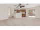 Open living space with kitchen, dining, and living room with neutral carpet at 3441 E Melody Dr, Phoenix, AZ 85042