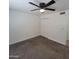 This cozy bedroom features neutral carpeting, a ceiling fan, and a closet for storage at 3645 N 69Th Ave # 99, Phoenix, AZ 85033
