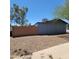 The exterior of the home with privacy wall and landscape at 3645 N 69Th Ave # 99, Phoenix, AZ 85033
