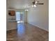 A spacious living room with tile floors and a ceiling fan at 3645 N 69Th Ave # 99, Phoenix, AZ 85033