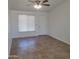 Inviting living room featuring tile floors, ceiling fan and lots of natural light at 3645 N 69Th Ave # 99, Phoenix, AZ 85033