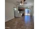 Open-concept living room with seamless flow to kitchen and patio access at 3645 N 69Th Ave # 99, Phoenix, AZ 85033