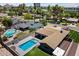 Aerial view showcases the house and pool area in a neighborhood with mature landscaping at 4202 E Catalina Dr, Phoenix, AZ 85018