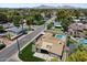 Aerial view of a home nestled in a lush neighborhood, with a swimming pool and mountain views in the distance at 4202 E Catalina Dr, Phoenix, AZ 85018