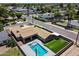 A high aerial view displays a house with a backyard pool in a neighborhood with lush greenery and multiple trees at 4202 E Catalina Dr, Phoenix, AZ 85018