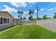 Lush green backyard featuring artificial turf, a storage shed, and a tall privacy wall at 4202 E Catalina Dr, Phoenix, AZ 85018
