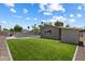 Expansive backyard featuring artificial turf, a sparkling pool, and a charming exterior view of the home at 4202 E Catalina Dr, Phoenix, AZ 85018