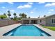 Backyard oasis featuring a sparkling pool, covered patio, and lush landscaping at 4202 E Catalina Dr, Phoenix, AZ 85018