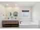 Modern bathroom featuring a double vanity, separate soaking tub, and modern fixtures at 4202 E Catalina Dr, Phoenix, AZ 85018