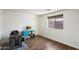 Bright bedroom features wood floors, a window, and a built-in workspace with blue cabinets at 4202 E Catalina Dr, Phoenix, AZ 85018