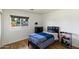 Cozy bedroom with hardwood floors, a large window, and a comfortable bed at 4202 E Catalina Dr, Phoenix, AZ 85018