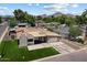 Striking modern home with a well-manicured lawn, clean lines, and a spacious driveway in a suburban neighborhood at 4202 E Catalina Dr, Phoenix, AZ 85018