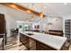 Bright modern kitchen featuring a large island, hardwood floors, stainless steel appliances, and stylish pendant lighting at 4202 E Catalina Dr, Phoenix, AZ 85018