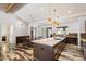 Bright modern kitchen featuring a large island, hardwood floors, stainless steel appliances, and stylish pendant lighting at 4202 E Catalina Dr, Phoenix, AZ 85018