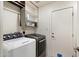 Well-organized laundry room with modern washer and dryer and ample storage space at 4202 E Catalina Dr, Phoenix, AZ 85018