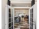 Inviting open-concept living space with stylish flooring, French doors, and abundant natural light at 4202 E Catalina Dr, Phoenix, AZ 85018