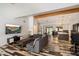 Bright living room featuring a modern sofa, unique flooring, an exposed beam, and an open layout at 4202 E Catalina Dr, Phoenix, AZ 85018