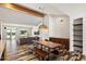 Open-concept living area with a large dining table, modern decor, hardwood floors, and abundant natural light at 4202 E Catalina Dr, Phoenix, AZ 85018