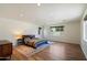 Spacious bedroom with hardwood floors, recessed lighting, large windows, and a comfortable king-size bed at 4202 E Catalina Dr, Phoenix, AZ 85018