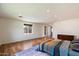 Spacious bedroom with hardwood floors, recessed lighting, large windows, and a comfortable king-size bed at 4202 E Catalina Dr, Phoenix, AZ 85018