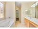 Well-lit bathroom featuring dual sinks, a soaking tub, and a separate walk-in shower at 4327 E Desert Sky Ct, Cave Creek, AZ 85331