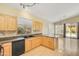 Kitchen boasts light wood cabinets, a black appliance package, and granite countertops at 4327 E Desert Sky Ct, Cave Creek, AZ 85331