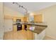 Bright kitchen with a breakfast bar, track lighting, and light wood cabinetry at 4327 E Desert Sky Ct, Cave Creek, AZ 85331