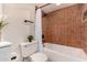 Bathroom featuring a white toilet, and shower with brown tiled walls at 461 W Holmes Ave # 323, Mesa, AZ 85210