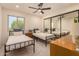 Bright bedroom featuring two twin beds, ceiling fan, and mirrored closet providing an airy feel at 461 W Holmes Ave # 323, Mesa, AZ 85210