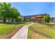 Serene community grounds showcasing lush green lawns, mature trees, pool gazebos, and inviting walkways at 461 W Holmes Ave # 323, Mesa, AZ 85210