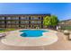 Inviting community pool surrounded by ample deck space and manicured landscaping for relaxing and socializing at 461 W Holmes Ave # 323, Mesa, AZ 85210