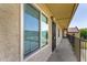 Exterior hallway featuring textured stucco, awning, and large windows with neighborhood view at 461 W Holmes Ave # 323, Mesa, AZ 85210