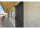 Close up on the exterior hallway leading to the front door, featuring a decorative security screen at 461 W Holmes Ave # 323, Mesa, AZ 85210