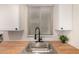Well-lit kitchen featuring butcher block countertops, a modern faucet, and tile backsplash at 461 W Holmes Ave # 323, Mesa, AZ 85210