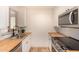 Modern kitchen with butcher block countertops, stainless appliances, and ample storage at 461 W Holmes Ave # 323, Mesa, AZ 85210