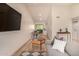 Open-concept living room with hardwood floors, a dining area, and a stacked washer/dryer at 461 W Holmes Ave # 323, Mesa, AZ 85210