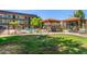 Inviting pool area featuring shade canopies, lounge seating, and a secure fence for relaxation and recreation at 461 W Holmes Ave # 323, Mesa, AZ 85210