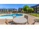 Comfortable poolside seating area with tables and chairs, perfect for enjoying the community pool and surrounding views at 461 W Holmes Ave # 323, Mesa, AZ 85210