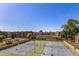Aerial view of community tennis courts and nearby condos on a bright day at 461 W Holmes Ave # 323, Mesa, AZ 85210