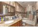 Well-lit bathroom with decorative tile work, granite vanity, framed mirror and shower-tub combo at 4627 W Laurie Ln, Glendale, AZ 85302