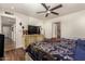 Cozy bedroom with a dresser, mounted TV, and a doorway leading to an en-suite bathroom at 4627 W Laurie Ln, Glendale, AZ 85302