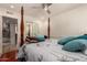 Bedroom showcasing a four-poster bed, ceiling fan, and access to a bathroom with a mirrored sliding door at 4627 W Laurie Ln, Glendale, AZ 85302