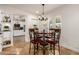 Cozy dining area with a round table, seating for four, and view of the adjacent kitchen at 4627 W Laurie Ln, Glendale, AZ 85302