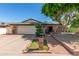 Charming single-story home with well-manicured lawn, brick accents, mature trees, and a two-car garage at 4627 W Laurie Ln, Glendale, AZ 85302