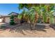 Inviting single-story home with mature landscaping, a brick pathway, and a covered porch area at 4627 W Laurie Ln, Glendale, AZ 85302