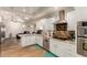 Bright kitchen with granite countertops, stainless steel appliances, white cabinetry and eat-in bar at 4627 W Laurie Ln, Glendale, AZ 85302