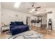 Open-concept living room featuring vaulted ceilings, skylights, tile flooring, and access to the kitchen at 4627 W Laurie Ln, Glendale, AZ 85302